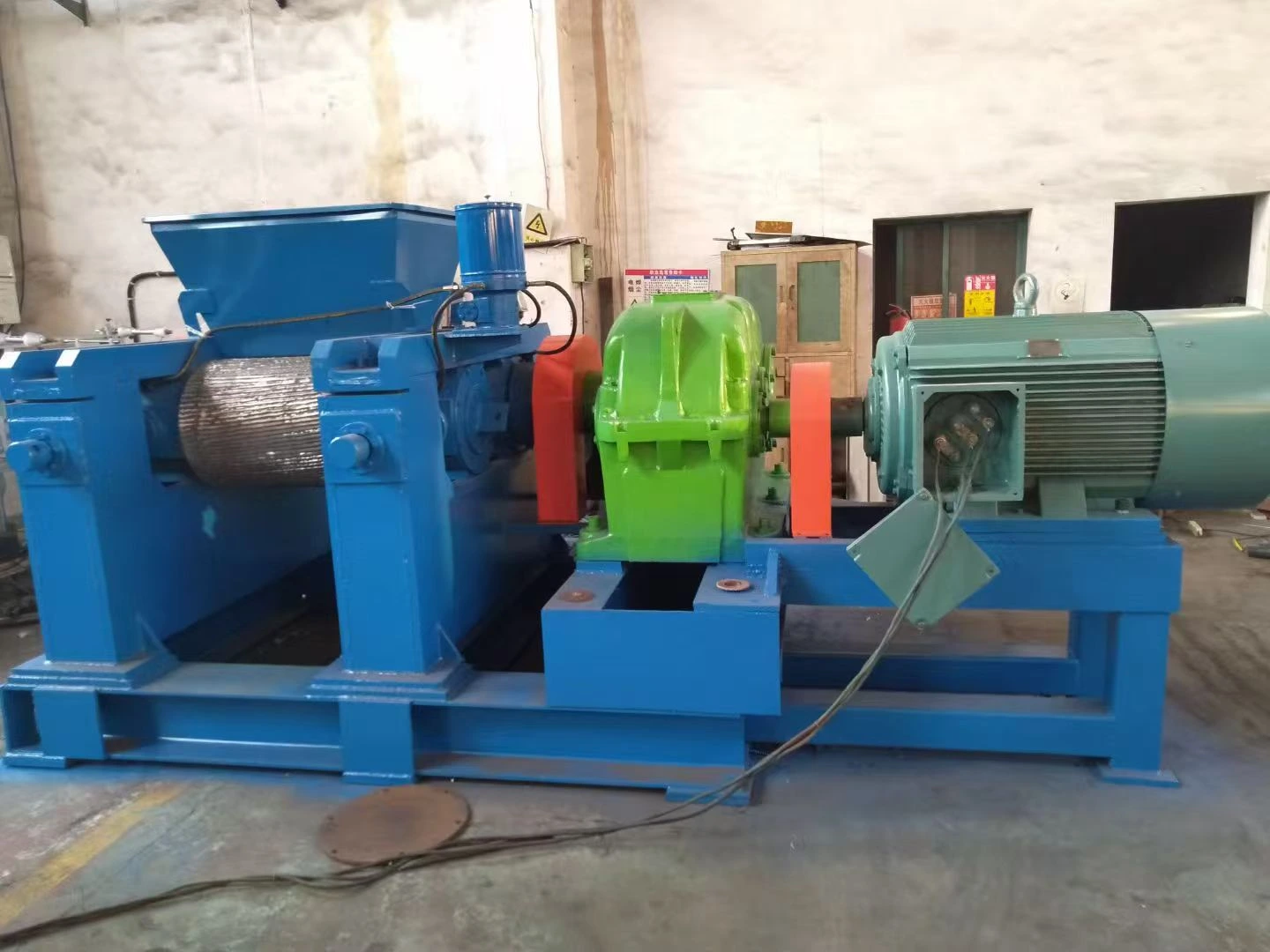 Blue and green industrial shredder for rubber processing