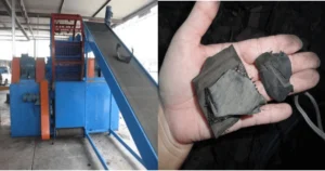 Industrial tire shredder machine for waste tire recycling, equipped with conveyor feeding system for cutting whole tires into rubber blocks.